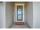 Inviting entryway with a gray door, welcome mat, and 'Home Sweet Home' decor at 2867 Matera Dr, St Cloud, FL 34771