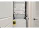 Compact laundry closet with stacked washer and dryer at 3171 Paradox Cir # 403, Kissimmee, FL 34746