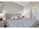 Main bedroom with plush bedding, modern lamps and ensuite bathroom at 3171 Paradox Cir # 403, Kissimmee, FL 34746