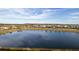 Community lake view with homes and landscape at 3171 Paradox Cir # 403, Kissimmee, FL 34746