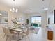 Open concept dining room with living room and balcony view at 3171 Paradox Cir # 403, Kissimmee, FL 34746