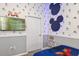 Playful bedroom with Mickey Mouse wall decor and a TV at 3171 Paradox Cir # 403, Kissimmee, FL 34746