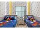 Mickey Mouse themed bedroom with twin beds, nightstands, and playful decor at 3171 Paradox Cir # 403, Kissimmee, FL 34746