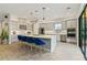 Bright kitchen with an island, blue velvet barstools, and stainless steel appliances at 3768 Via Mazzini Ct, Kissimmee, FL 34759