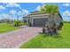 Single-story home with paver driveway, landscaping, and two-car garage at 3768 Via Mazzini Ct, Kissimmee, FL 34759