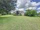 Beautiful house exterior with large yard and mature trees at 2376 Gunn Rd, Kissimmee, FL 34746