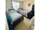 Two twin beds in a well-lit bedroom with window at 3502 Windy Walk Way # 2208, Orlando, FL 32837