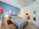 King bed with blue accent wall and geometric bedding at 3075 Barbados Ln, Haines City, FL 33844