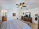Large bedroom with ensuite bathroom access and a ceiling fan at 3075 Barbados Ln, Haines City, FL 33844