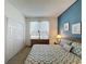 King bed with blue accent wall and geometric bedding at 3075 Barbados Ln, Haines City, FL 33844