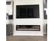 Modern living room fireplace with a large TV above at 8079 Nemours Pkwy, Orlando, FL 32827