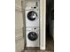 Laundry closet with stacked washer and dryer at 8079 Nemours Pkwy, Orlando, FL 32827