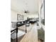 Open living space, showcasing a sectional sofa and kitchen at 8079 Nemours Pkwy, Orlando, FL 32827