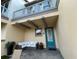 Private patio with seating area and teal door at 8079 Nemours Pkwy, Orlando, FL 32827