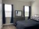 Bright bedroom with a dresser and large windows at 8079 Nemours Pkwy, Orlando, FL 32827