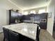 Spacious kitchen with granite island and dark cabinetry at 8079 Nemours Pkwy, Orlando, FL 32827