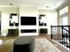 Open living room with fireplace, TV and staircase at 8079 Nemours Pkwy, Orlando, FL 32827