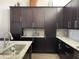Modern kitchen with ample cabinet space and granite countertops at 8079 Nemours Pkwy, Orlando, FL 32827