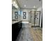 Elegant bathroom with double sinks, soaking tub, and a frameless shower at 8079 Nemours Pkwy, Orlando, FL 32827