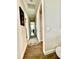 Long hallway with light neutral walls and wood flooring at 8079 Nemours Pkwy, Orlando, FL 32827