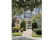 Charming townhome with landscaped walkway and lush greenery at 8079 Nemours Pkwy, Orlando, FL 32827