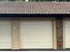 Attached garage with off-white door and brick exterior at 300 New Waterford Pl # 204, Longwood, FL 32779