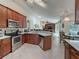 Open concept kitchen with breakfast bar and stainless steel appliances at 7978 Magnolia Bend Ct, Kissimmee, FL 34747