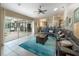 Open-concept living room with view of the pool and dining area at 7978 Magnolia Bend Ct, Kissimmee, FL 34747