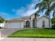 Beautiful home with a well-manicured lawn and palm trees at 7978 Magnolia Bend Ct, Kissimmee, FL 34747