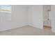 Bright bedroom with plush carpeting and adjacent bathroom at 2043 Stetson Ct, Eagle Lake, FL 33839