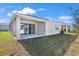 Home exterior showcasing patio and grassy backyard at 2043 Stetson Ct, Eagle Lake, FL 33839