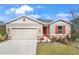 New construction home with red door and stone accents at 2043 Stetson Ct, Eagle Lake, FL 33839