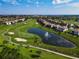 Aerial view of golf course and pond at 8971 Stinger Dr, Davenport, FL 33896