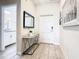 Bright and airy entryway with mirror and half bath at 8971 Stinger Dr, Davenport, FL 33896