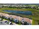 Aerial view of townhouses, pond, and community at 8971 Stinger Dr, Davenport, FL 33896