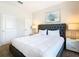 Bedroom with a queen-size bed, nightstands, and large window at 8971 Stinger Dr, Davenport, FL 33896
