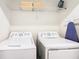 Laundry room with washer, dryer, and shelving at 8971 Stinger Dr, Davenport, FL 33896
