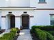 Townhouse entry with double doors and landscaping at 8971 Stinger Dr, Davenport, FL 33896