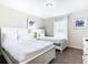 Well-lit bedroom featuring two twin beds and a dresser at 8971 Stinger Dr, Davenport, FL 33896
