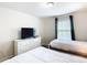 Bedroom with two beds, dresser and TV at 8971 Stinger Dr, Davenport, FL 33896
