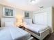 Bedroom with two twin beds, nightstand and closet at 8971 Stinger Dr, Davenport, FL 33896