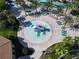 Aerial view of resort-style pool with water features, lounge chairs, and palm trees at 8971 Stinger Dr, Davenport, FL 33896