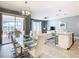 Open concept dining area with glass table and chandelier at 8971 Stinger Dr, Davenport, FL 33896