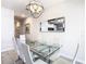 Modern dining room with glass table and chandelier at 8971 Stinger Dr, Davenport, FL 33896