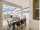 Covered patio with table and chairs overlooking the pool at 8971 Stinger Dr, Davenport, FL 33896