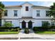 Two-story townhouse with Spanish tile roof and landscaping at 8971 Stinger Dr, Davenport, FL 33896