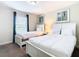Bedroom with two twin beds, window and dresser at 8971 Stinger Dr, Davenport, FL 33896