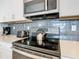 Close-up of stovetop, microwave, and other kitchen appliances at 8971 Stinger Dr, Davenport, FL 33896
