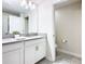 Bathroom with double vanity, large mirror, and access to a toilet at 8971 Stinger Dr, Davenport, FL 33896