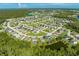 Aerial view showcasing a neighborhood with houses and a lake at 2662 Trafalgar Blvd, Kissimmee, FL 34758